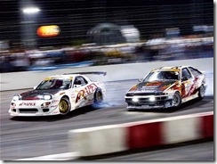 130_0312_01_z mazda_rx7_and_toyota_corolla front_drift_view