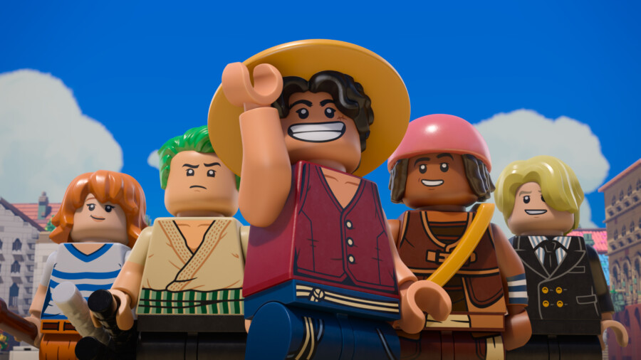 "Group of five LEGO minifigures in colorful outfits posing outdoors with blue sky and clouds, buildings in the background, central figure smiling and wearing a straw hat."