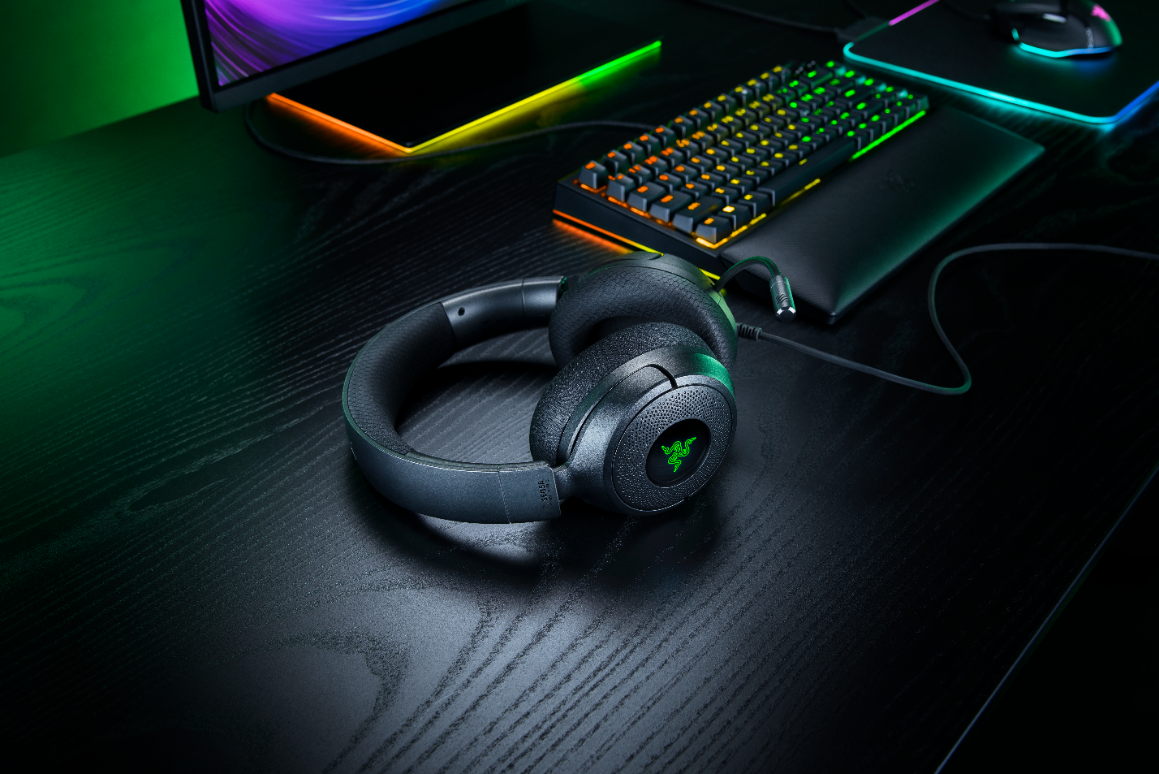 Headset com fio Razer Kraken V4 X Sensa HD Haptics sobre uma mesa gamer